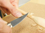 Michi Hamono MT-500 small whittling knife with a short pointed steel blade and natural wood handle.